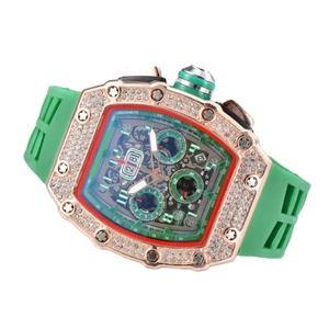 Luxury rose gold tonneau watch with iced-out bezel, skeleton dial, and green rubber strap