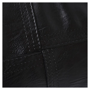 Macro shot of black pebbled leather texture and reinforced double stitching on handbag