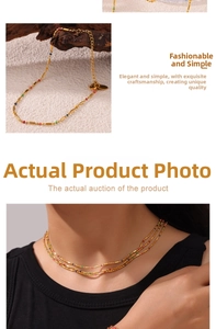 Detail of gold beaded necklace with colorful spacers and adjustable lobster clasp on model