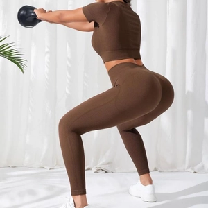 Seamless brown ribbed yoga set featuring short sleeve crop top and high waist leggings