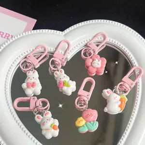 Set of cute cartoon bunny resin keychains in pink and white with carrot and flower motifs