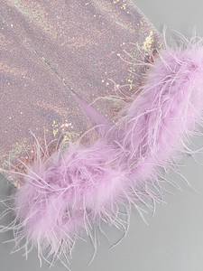 Detail of light purple sequins and ostrich feather trim on a luxury evening dress