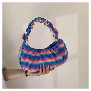 Detailed view of rainbow gradient pleated handbag with satin finish and cloud shape