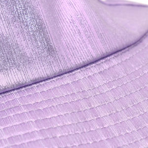 Macro shot of purple metallic bucket hat showing fine texture and reinforced brim stitching