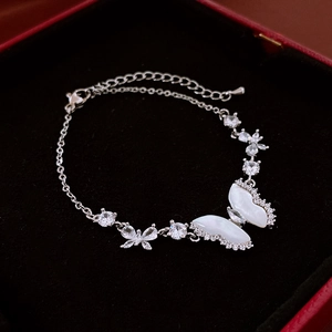 Detailed view of silver butterfly bracelet with mother of pearl and zircon stones