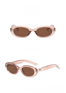 Detail view of transparent pink oval sunglasses with tea lenses and star metal accents