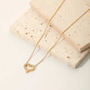 18K gold hollow heart pendant necklace with shimmering cubic zirconia on stone base