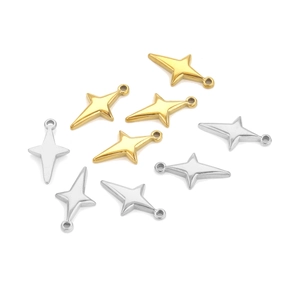Detailed view of gold and silver four-pointed star charms for DIY jewelry making