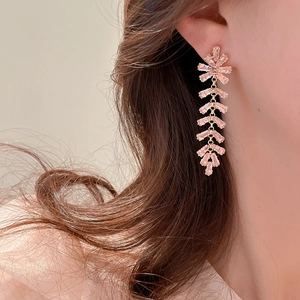 Detail of pink crystal tassel earrings on a model showing elegant long cascading rhinestones