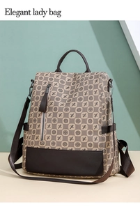 Close-up of printed canvas backpack with top handle and vertical zipper side pockets