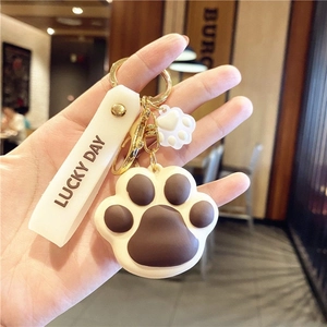 Cute brown and white cat paw keychain with Lucky Day tag and golden metal ring