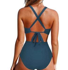 Detail view of the back of a grey-blue one-piece swimsuit with cross straps and lace-up design