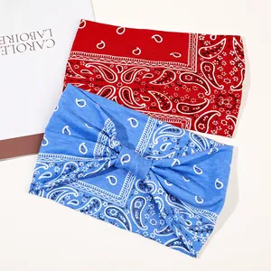 Detail of red and blue paisley print wide headbands showing soft stretch fabric texture