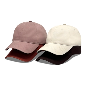 Set of vintage washed cotton baseball caps in pink, cream, red, and brown colors