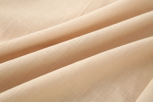 Macro shot of breathable linen fabric texture in light beige for women shirt
