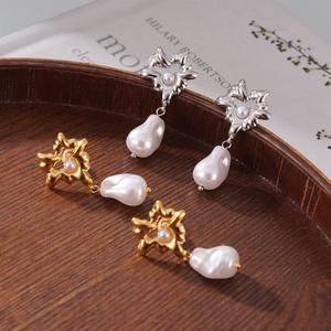Retro gold and silver heart earrings with Baroque pearls on textured wooden display