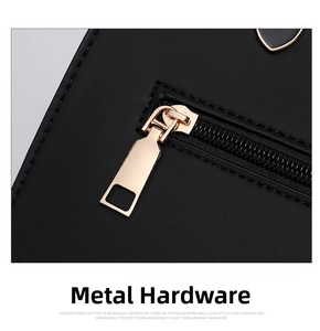 Close-up of light gold metal zipper and stitching on black pebbled leather bag