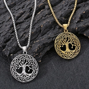 Detailed view of silver and gold tree of life pendants with celtic knot textures