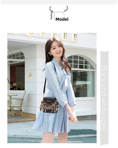 Chic mini crossbody bag with heart pattern and silk scarf handle detail on a model