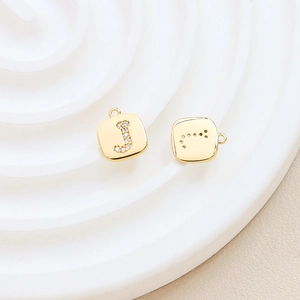 Detailed view of a gold-plated letter J pendant featuring sparkling cubic zirconia stones
