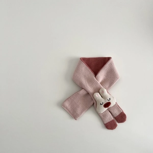 Detail of pink knitted baby scarf with 3D bunny head and cross-through design