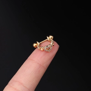 Detailed macro view of a 20G stainless steel gold heart ear stud with micro-set zircons