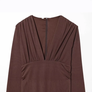 Chocolate brown V-neck dress featuring elegant pleated details and front hidden zipper