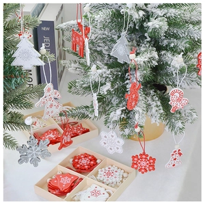Detail of red and white wooden Christmas ornaments with snowflakes in a storage box