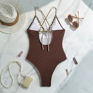 Detailed texture of brown ribbed fabric and lace-up back design on a swimsuit