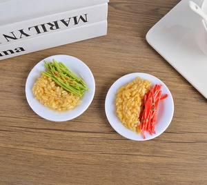 Detailed macro view of two miniature PVC food models with realistic textures on wood