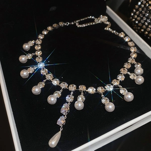 Close-up of pearl necklace with teardrop zircon in black velvet gift box