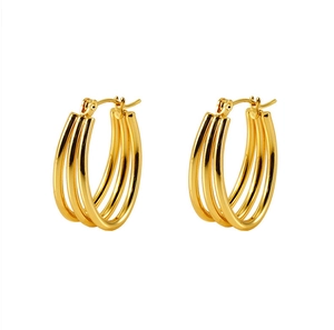 Macro detail of multi-layered gold stainless steel hoop earrings with polished finish