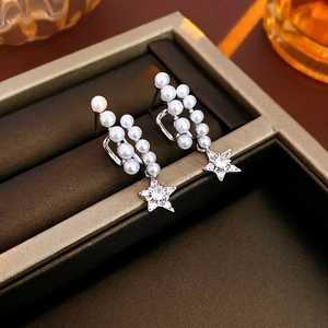 Elegant star and pearl drop earrings in silver finish, showcased in a luxury jewelry box