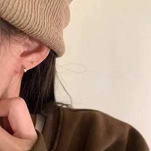 Detailed view of silver hoop earrings featuring a minimalist textured bamboo joint design