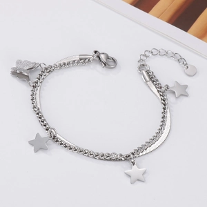 Close-up of double-layer silver bracelet with star charms and butterfly pendant