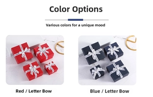 Detail of square jewelry gift boxes in red and navy blue with printed ribbon bows