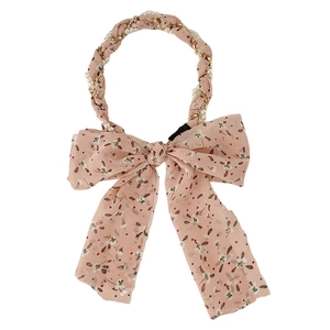 Pink floral headband with pearl chain and large soft fabric bow on white background