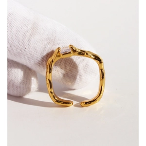 Irregular gold lava texture square ring with clear cubic zirconia on white background