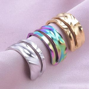 Macro detail of wave textured 304 stainless steel rings in gold, silver and multicolor