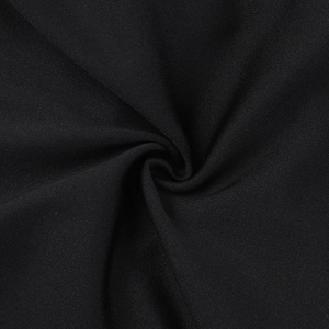 Close-up of premium black fabric texture with elegant folds and drape detail on the dress