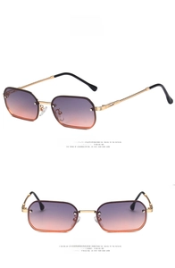 Detail of grey-pink gradient rectangular sunglasses with golden spiral metal temples