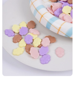 Macro shot of 2cm mini cloud resin charms with Angels engraving in pastel macaron colors