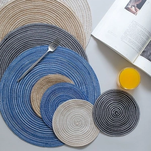 Set of woven round heat resistant table mats and coasters in various colors and sizes