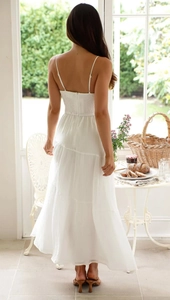 Détail de la robe longue blanche à volants avec dos élastique froncé et bretelles