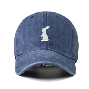 Navy blue washed cotton baseball cap with white embroidered rabbit silhouette on front