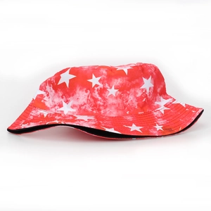 Detail of red tie-dye bucket hat featuring white star patterns and casual canvas texture