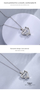 Detail of heart-shaped Mama necklace pendant with cubic zirconia flower in platinum color