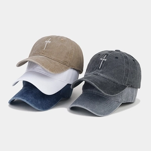 Detail of five vintage washed cotton baseball caps with PEACE embroidery in various colors
