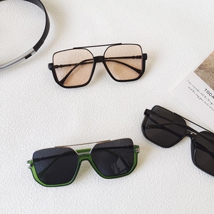 Detailed flat lay of oversized retro sunglasses with metallic double bridge in three colors