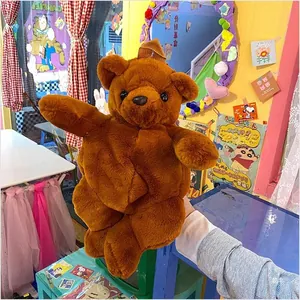Detailed view of the soft dark brown plush bear texture and cute facial features